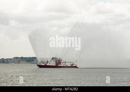 Die Fire Fighter II, ein feuerlöschboot in New York City, Sprays Wasser in den Hafen von New York. Stockfoto