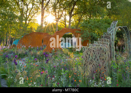 Sonnenaufgang über Skulpturen von naturalistischen Einpflanzung in der David Harber und Savills Garten von Nic Howard an der RHS Chelsea Flower Sh gestalteten Garten Stockfoto