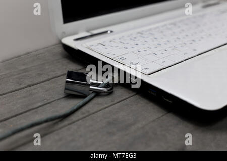 Notebook Sicherheit im Internet mit LAN Kabel am Zahlenschloss. Stockfoto