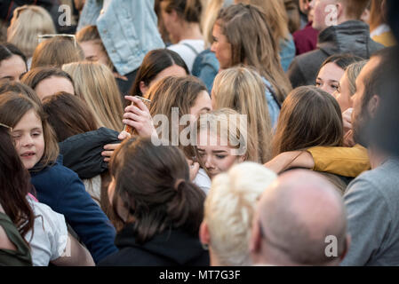 Zwei Mädchen schreien und Hug während des Manchester zusammen Chor Konzert im Gedenken an die Opfer der Arena Bombenattentat in Manchester, Großbritannien, am 22. Mai 2018. Prinz William und der britische Premierminister Theresa May zusammen mit anderen Politikern, sowie Angehörige der Getöteten, und Rettungskräfte zur Szene des Terror Angriff, während Tausende von Menschen in Manchester Dienstag versammelten sich am ersten Jahrestag des Terrorangriffs in der Stadt die 22 Toten. Stockfoto