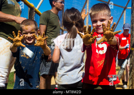 CAMP SCHWAB, Okinawa, Japan - Kinder für ein Foto posieren nach dem Spielen im Schlamm in einem softballspiel 12. Mai an Bord Camp Schwab, Okinawa, Japan. Mitglieder der Okinawa Verteidigung Bureau, Henoko und Marines versammelt, bereit für Ihre softball Turnier zu finden, ihre Ausgangsbedingungen in Wasser bedeckt. Durch die Zusammenarbeit der Spiele begonnen, so dass die ODB, Henoko und Marine Mannschaften zusammen durch einige freundliche Konkurrenz zu kommen. (U.S. Marine Corps Foto von Pfc. Nicole Rogge) Stockfoto