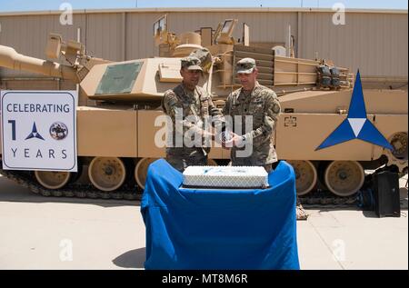 Us-Armee Oberstleutnant Craig Martin, Commander, Task Force Battle, Betrieb inhärenten lösen kann, und der Befehl "Sgt. Maj. Louis De Leon, Task Force Battle Sgt. Maj., bereiten einen Kuchen Markierung des III Korps 100 Jahr Jubiläum zu schneiden, 16. Mai 2018, im Camp Arifjan, Kuwait. Die III Korps wurde während des Zweiten Weltkrieges organisierte ich, am 16. Mai 1918, in Frankreich. Es war der dritte von vier neue Corps aktiviert Alliierten Kräfte wie die American Expeditionary Force im Kampf gegen die Mittelmächte in Europa unterstützen. (U.S. Air National Guard Foto von Master Sgt. De-Juan Haley) Stockfoto