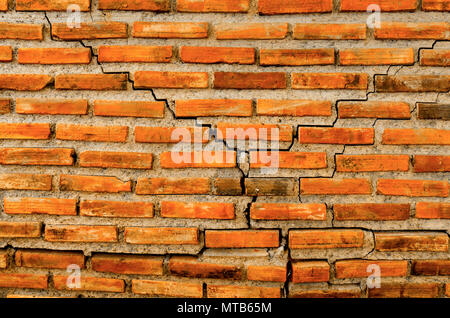 Der Riss Wand aus Ziegel und Backstein Hintergrund, rote riss Ziegel und Muster von Crack Mauer Hintergrund, alte Backsteinmauer und crack Textur und vinta Stockfoto