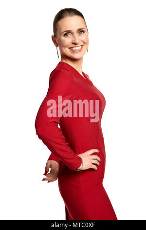 Studio shot von attraktiven lächelnden jungen Frau im roten Kleid, mit einem aufrichtigen Lächeln, auf weißem Hintergrund. Stockfoto