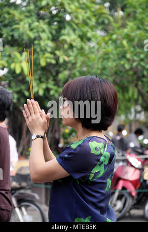 HO CHI MINH CITY, VIETNAM, 29. MAI 2018: Frau beten und Räucherwerk in Vollmond Tag verbrennen bei Pagode, einer traditionellen Kultur Buddhistische an Vietnam Stockfoto