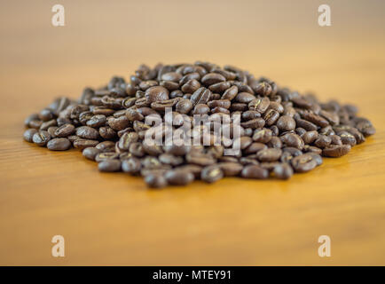 Damm von frischen Kaffeebohnen auf einem Tisch Stockfoto