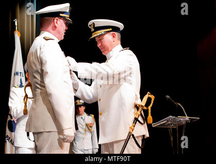 Hintere Adm. Dave Callahan, Kommandant der 8. Coast Guard Bezirk, Stifte Auslaufen eines Award auf Kapitän Peter Martin, Kommandeur der Sektor Houston-Galveston, während eine Change-of-Befehl und Ruhestand Zeremonie am San Jacinto College in Houston, April 24, 2017. Die Change-of-Befehl Zeremonie ist eine altehrwürdige, militärische Tradition, zu den Offizieren und berechtigtem Personal vermittelt, dass, obwohl die Autorität der Befehl von einer Person abgegeben wird und von einem anderen übernommen, es ist immer noch ohne Unterbrechung aufrechterhalten. Us-Küstenwache Stockfoto