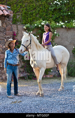 Katja Smith und ihre Tochter mit einem seltenen weißen Pferd bei Granitas de Animas Ranch - San Miguel de Allende, Mexiko Stockfoto