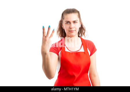 Junge weibliche Supermarkt oder SB-Warenhaus Arbeiter zeigen, Nummer drei mit Finger zum Zählen Einzelhandelskonzept auf weißem Hintergrund Stockfoto