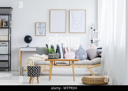 Pastellfarben girly Zimmer mit einfachen Sofa mit dekorativen Kissen Stockfoto