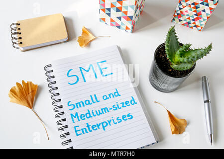 Small And Medium-sized Enterprises written in a notebook on white table Stockfoto