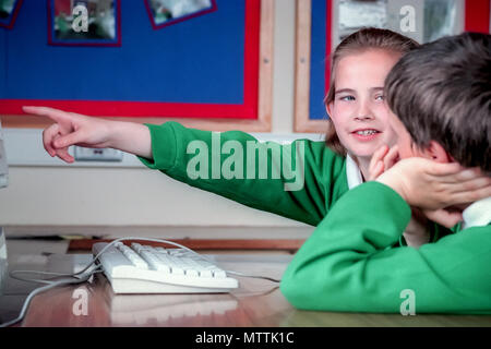 Schülerinnen und Schüler auf einem frühen Computer Stockfoto