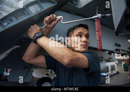 Arabischen Golf (25. April 2017) Aviation strukturellen Mechaniker Airman Lehrling Humberto Gonzalez arbeitet an einer F/A-18E Super Hornet an Bord der Flugzeugträger USS George H.W. Bush (CVN 77) (GHWB). GHWB ist in den USA der 5. Flotte Bereich für Maßnahmen zur Erhöhung der Sicherheit des Seeverkehrs auf die Verbündeten und Partnern zu beruhigen bereitgestellt, und der Freiheit der Schiffahrt und des freien Handels in der Region erhalten. Stockfoto