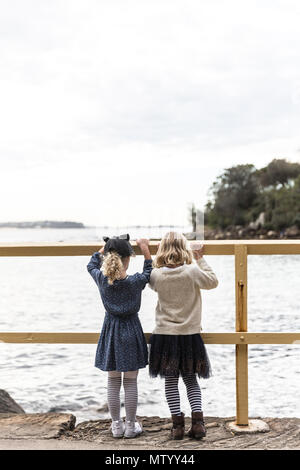 Zwei Mädchen mit einem Geländer heraus zum Meer, Sydney, New South Wales, Australien Stockfoto