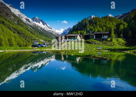 Spiegelungen der Berge und Häuser, Gouille, Arolla, Evolène, Schweiz, Stockfoto