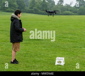 Biracial junge fliegt Drone bei Weald Country Park Model Release statt Stockfoto