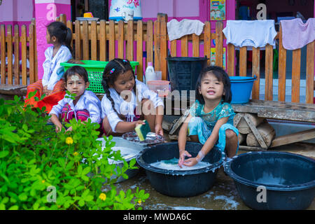 Kanchanaburi, Thailand - 8. September 2016: Kindergarten Kinder in ländlichen Kindergarten Geschirr, Schalen und Geschirr in schwarz Becken nach dem Mittagessen Stockfoto