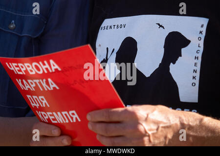 Kryvyi Rih, Ukraine. 1. Juni 2018. Mann im t-shirt mit Silhouetten der Krim politischen Gefangenen Oleh Sentsov und Olexandr Kolchenko hält rotes Papier mit Inschrift "Rote Karte für den Kreml während der Aktion 'Frei' in Sentsov Kryvyi Rih (Ukraine) am 1. Juni 2018 Credit: Dmytro Aliokhin/Alamy leben Nachrichten Stockfoto