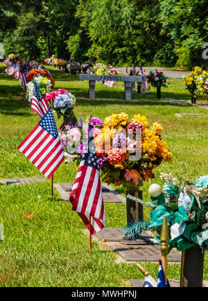 HAUGHTON, LA, USA - 28. MAI 2018: Fahnen und Blumenarrangements schmücken die Gräber von Kriegsveteranen. Stockfoto