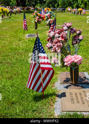 HAUGHTON, LA, USA - 28. MAI 2018: Fahnen und Blumenarrangements schmücken die Gräber von Kriegsveteranen. Stockfoto