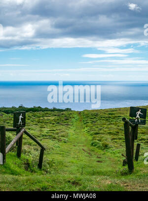 Wandern Wanderweg Schildern über Feld nach unten zu Pazifischen Ozean, Osterinsel, Rapa Nui, Chile Stockfoto