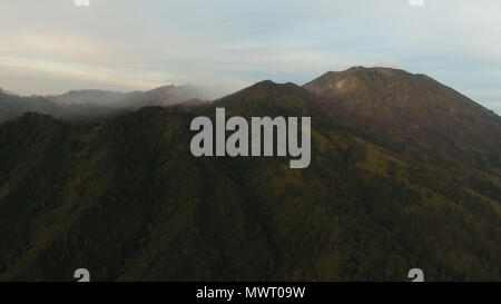 Schönen Sonnenuntergang in den Bergen auf Jawa Island, Indonesien. Luftaufnahme der Berge Landschaft unter Himmel mit Wolken, Regenwald. Stockfoto