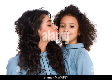 Nahaufnahme der Mutter küssen ihre Tochter auf weißem isoliert Stockfoto