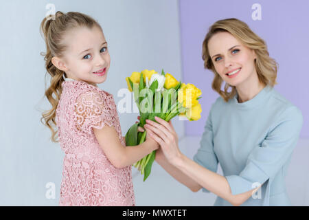 Mutter und Tochter holding Strauß Frühlingsblumen am 8. März Stockfoto