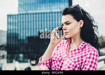 Attraktive spontane Frau am Telefon zu sprechen. Authentizität und Spontaneität. Authentische Gespräch über das Telefon. Stockfoto