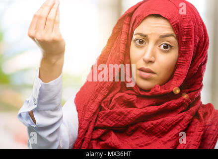 Junge arabische Frau, tragen, Hijab wütend Gestik, die typisch italienische Geste mit der Hand, die Kamera schaut Stockfoto