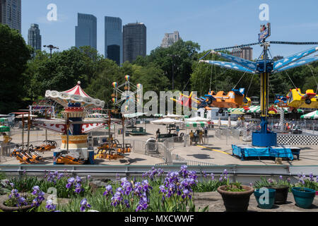 Viktorianischen Gärten, Karneval Fahrten im Central Park mit der Manhattan Skyline im Hintergrund, NYC, USA Stockfoto