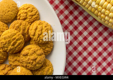 Köstliche gelb Cookie von Mais. Süße Speisen von Festa Junina, eine typisch brasilianische Party, Urlaub Veranstaltung im Juni. Snack auf Platte, Rot karierte Tabelle. Stockfoto