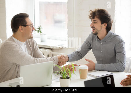 Arbeitnehmer beglückwünschen Geschäftsfreund mit Handshake an Compa Stockfoto