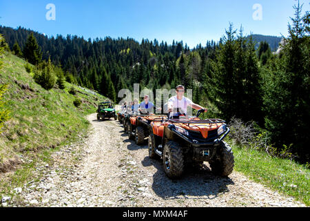 Eine Reisegruppe reist auf ATVs und UTVs auf die Berge Stockfoto