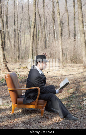 Man liest einen Roman im Wald, Porträt Stockfoto