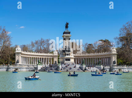 Madrid, El Retiro Park. Bootfahren auf dem estanque Grande del Retiro mit der Alfonso XII Denkmal hinter, Parque del Buen Retiro, Madrid, Spanien. Stockfoto