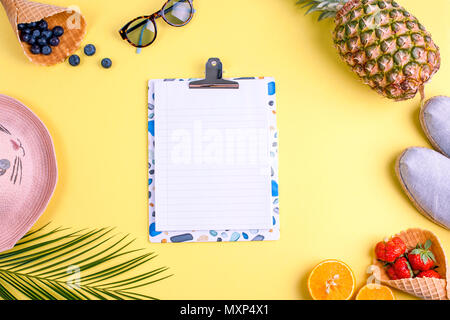 Tropische Früchte und Beeren, und einem Palm Zweig auf gelbem Hintergrund. Freier Platz für Text auf einer weißen Tafel in der Mitte. Zubehör für Urlaub und Entspannung. Kopieren Sie Raum, flach Stockfoto