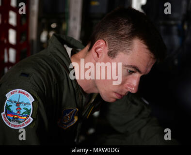 Erster Leutnant William Lawlor, eine C-130 Hercules Pilot von der 36th Airlift Squadron, Yokota Air Base, Japan, liest Flug charts vor Abflug Dez. 6, 2016 bei Andersen Air Force Base, Guam. Service für Mitglieder von der U.S. Air Force, U.S. Coast Guard und der US-Marine, mit internationaler Unterstützung von der Japan Air Verteidigung-kraft und Royal Australian Air Force kamen zusammen, Lebensmittel, Kleidung, Spielzeug und die Versorgung der Menschen in der gesamten pazifischen Raum während des 65. jährlichen Betrieb Weihnachten Fallen zu bringen. (U.S. Air Force Foto von Airman 1st Class Gerald Willis) Stockfoto