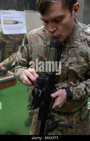 Royal Air Forces Mitglied (Ausbilder) der Gemeinsamen Europäischen Training Team, Nullen der Britischen Soldaten Waffe zu örtlichen Einheiten während der L 85 A2 rifle Kalibrierung bei der Schulung Support Center Benelux 25 m-Indoor Bereich zugewiesen ist, in Chièvres Air Base, Belgien, November 30, 2016. Die britischen Truppen unter Aufsicht der britischen Joint European Training Team (USA ausgebildet Armee Foto durch visuelle Information Specialist Pascal Demeuldre) Stockfoto