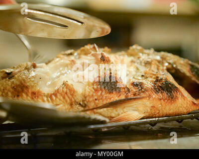 Fisch vom Grill serviert und serviert mit Gemüse im Restaurant. Stockfoto