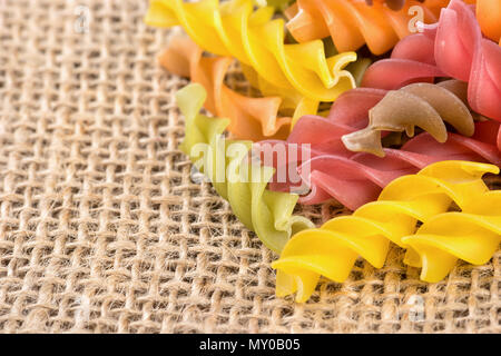 Streuen die farbige Pasta Fusilli Sacktuch Nahaufnahme Stockfoto