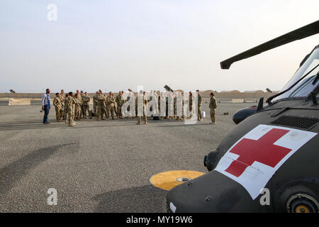 Einen Flug medic beauftragt der US-Army Central Soldaten, über Notfall Evakuierungen und medizinischen Hubschrauber Verfahren während einer medizinischen Ausbildung Veranstaltung Dez.19, 2016 in Camp Arifjan, Kuwait. Die Ausbildung einer einleitenden Lektion für medizinisches Personal, das Vertrautmachen mit militärischen Arbeitshunde, Wurf Training, Ausbildung und medizinische Evakuierung Training. (U.S. Armee Foto von Sgt. Angela Lorden) Stockfoto