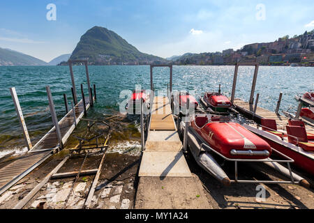 View of Lugano lakefront with the typical pedalos on a spring day, Canton Ticino, Switzerland. Stockfoto