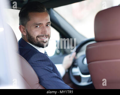 Unternehmer sitzen am Steuer eines Autos, und wenn man die Kamera Stockfoto