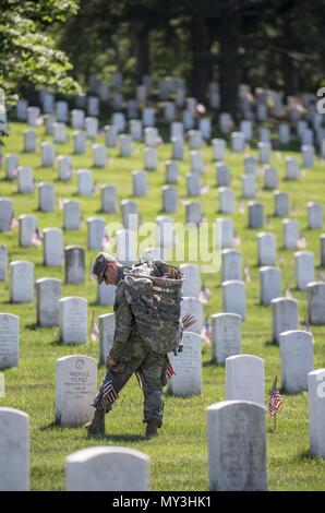 Ein Soldat aus der 3D-US-Infanterie Regiment (Die Alte Garde) Orte USA Fahnen auf Grabsteinen in Abschnitt 38 bei der Flaggen auf dem Arlington National Cemetery, Arlington, Virginia, 24. Mai 2018, 24. Mai 2018. Seit mehr als 60 Jahren Soldaten aus der alten Garde haben gefallenen Helden unserer Nation, indem sie US-Fahnen auf grabstätten für Service Mitglieder sowohl auf dem Arlington National Cemetery und die US-Soldaten" und "Flieger Home National Cemetery gerade vor dem Memorial Day Wochenende begraben geehrt. Innerhalb von vier Stunden, mehr als 1 000 Soldaten, 234, 537 Flaggen vor jedem Grabstein und Columba Stockfoto