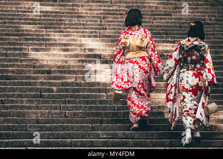 Zwei Mädchen tragen Kimonos Treppensteigen zu einem Tempel in Kyoto. Stockfoto