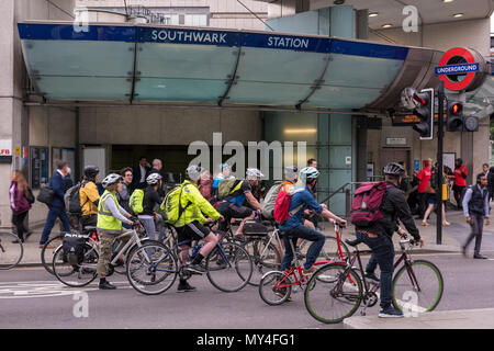 Eine große Anzahl von Pendlern auf Fahrrädern Radtouren in Central London im morgendlichen Berufsverkehr außerhalb von Southwark tube station an der Ampel arbeiten Stockfoto