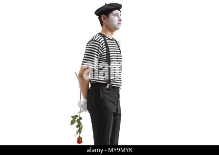 Traurig mime-Holding eine Rose hinter seinem Rücken isoliert auf weißem Hintergrund Stockfoto