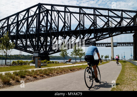 Radfahrer auf der Promenade Samuel de Champlain Radweg in Quebec, mit der St. Lawrence River in Pont du Quebec Brücke jenseits Stockfoto