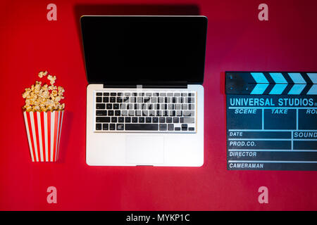 Laptop, Kreditkarte, Klappe, Popcorn. Filme und Kino Konzept Stockfoto